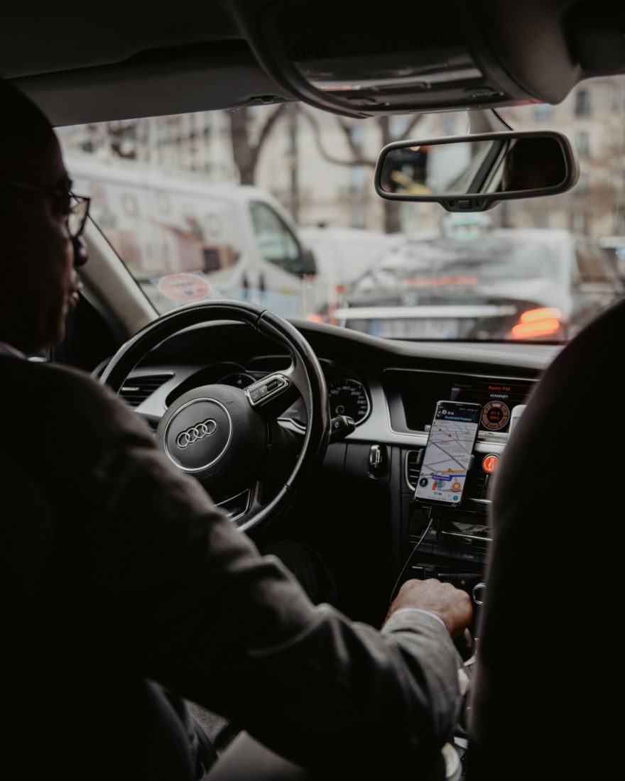 Interior view of a taxi with visible driver at the steering wheel