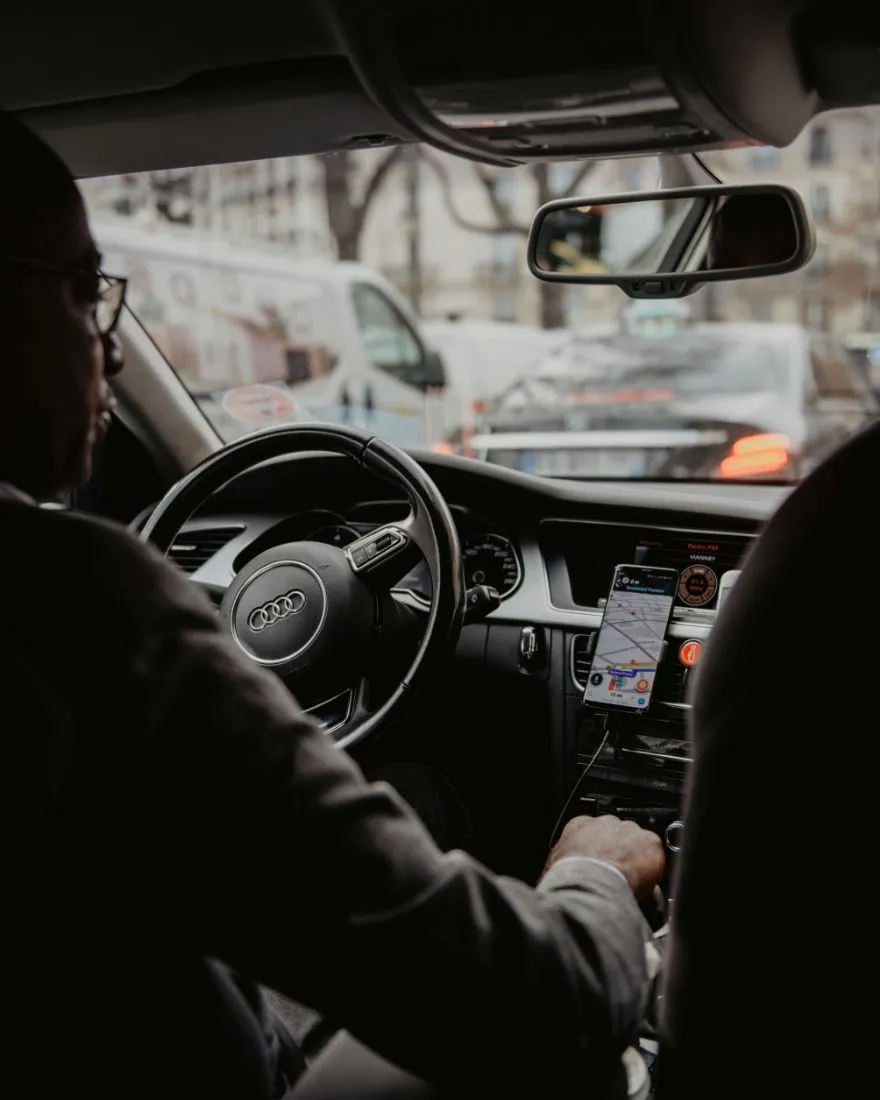 Interior view of a taxi with visible driver at the steering wheel