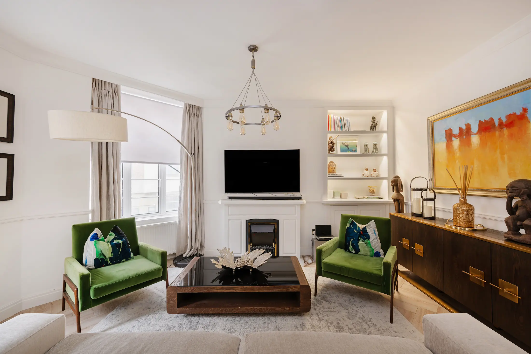 Casa Cribs living room with two green armchairs.