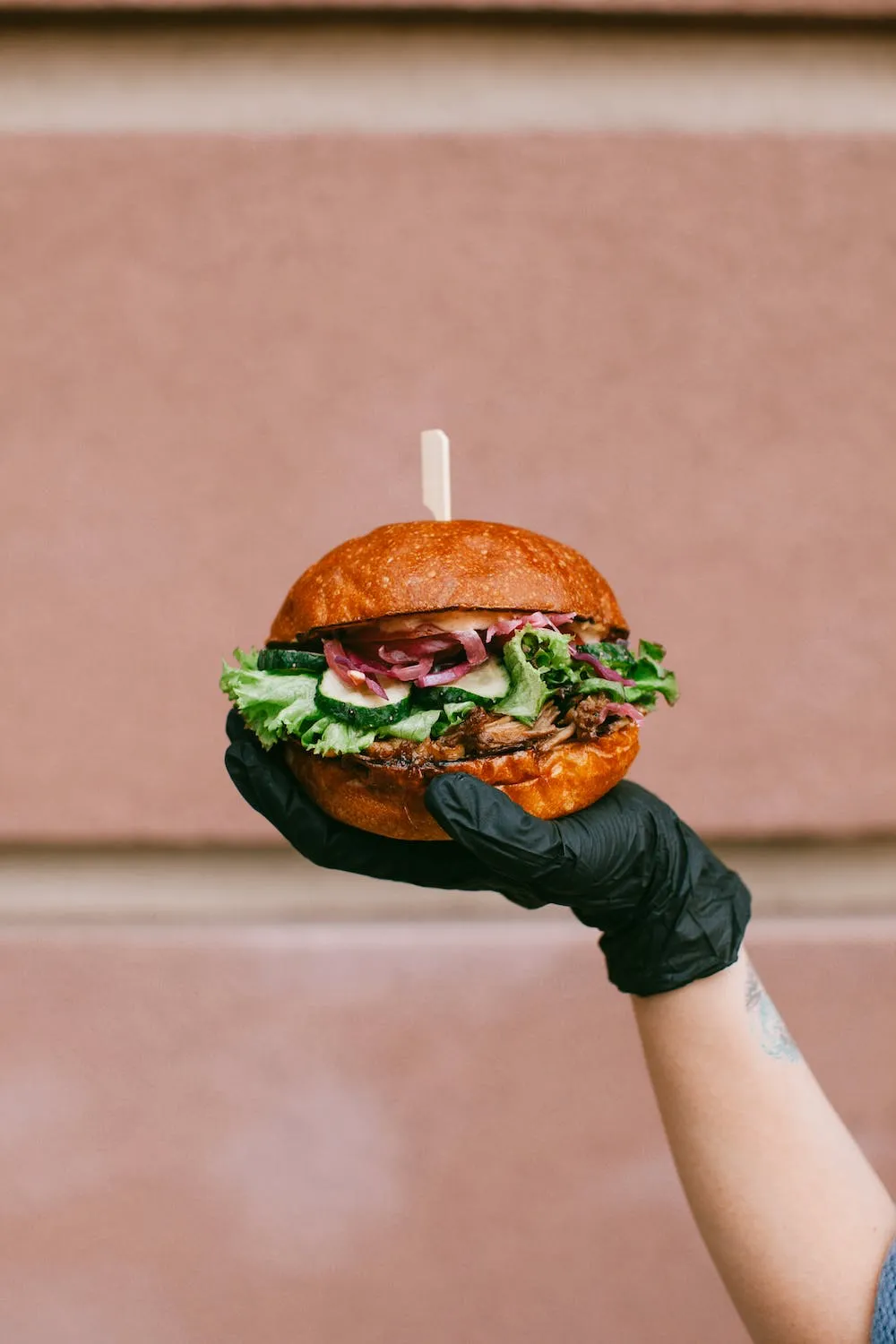A hand holding a burger