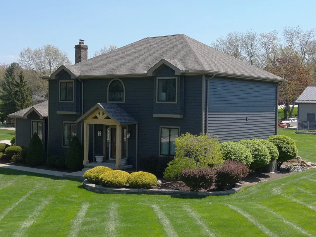 dark siding home with front landing timber covering