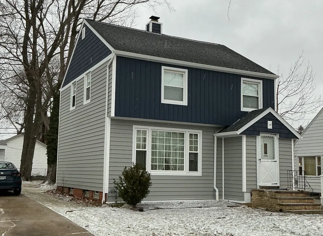 home in winter with accent blue vertical siding