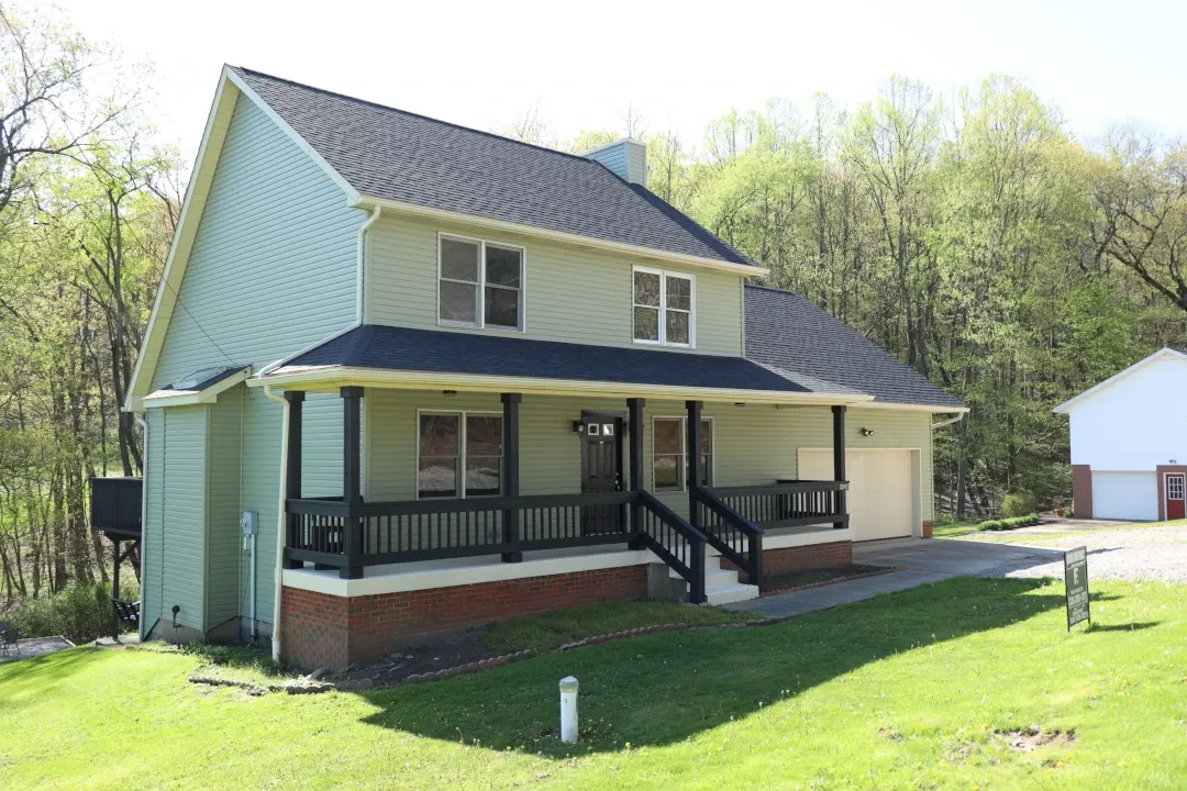 two story home with long front porch steps to walkway