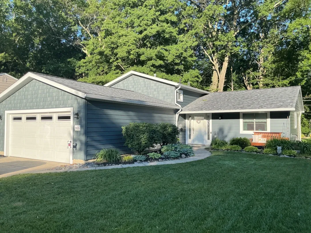 shingle roof home with shaker siding accent