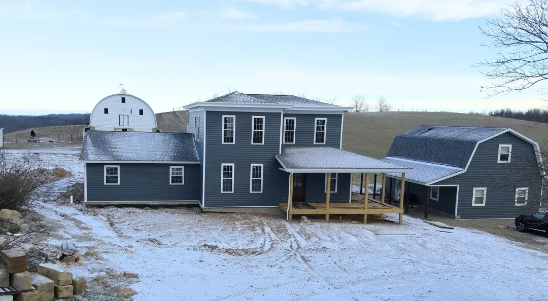blue siding home with wooden deck