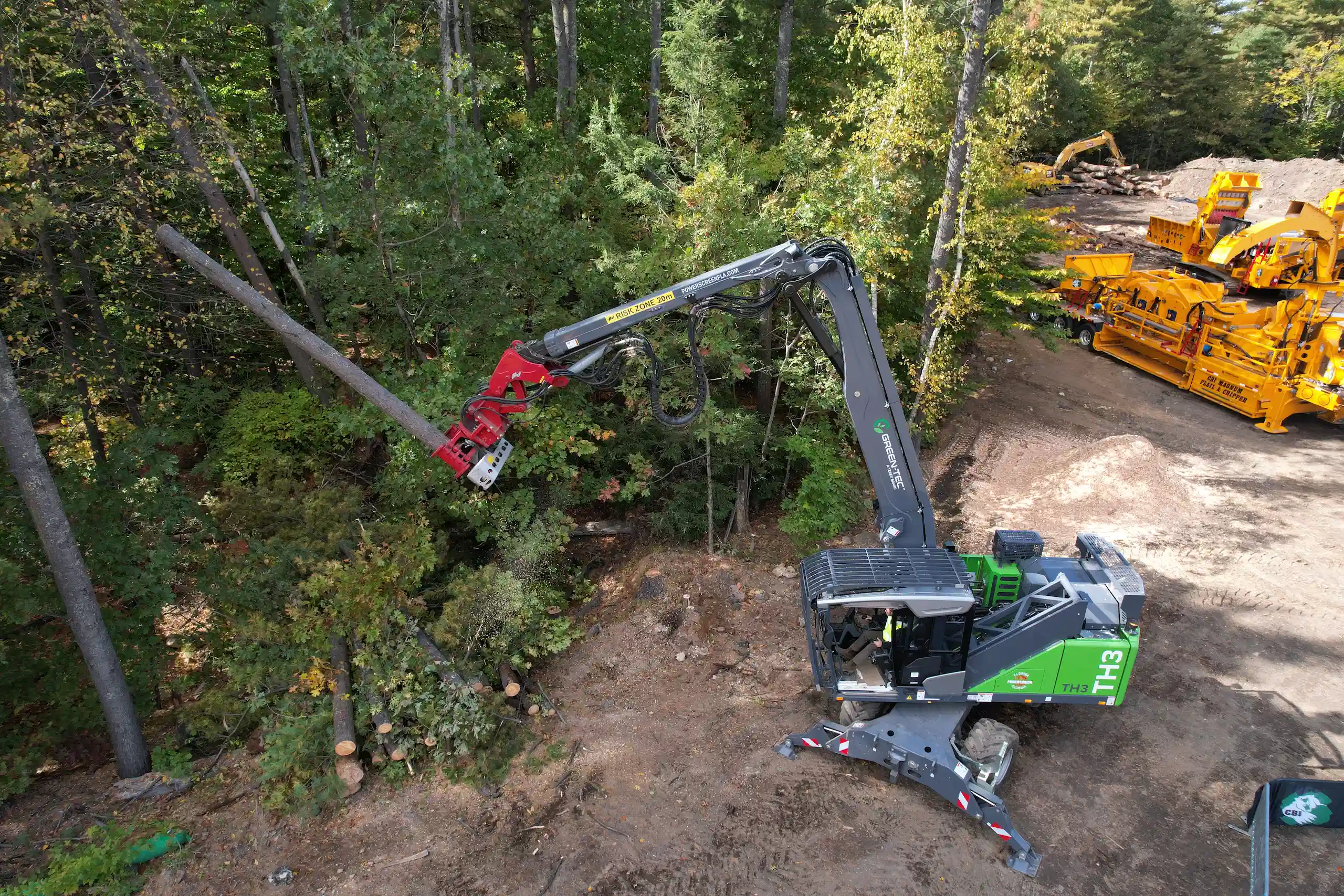 Green-Tec TH3 tree care handler using a grapple attachment to handle logs during controlled forestry and vegetation management work.