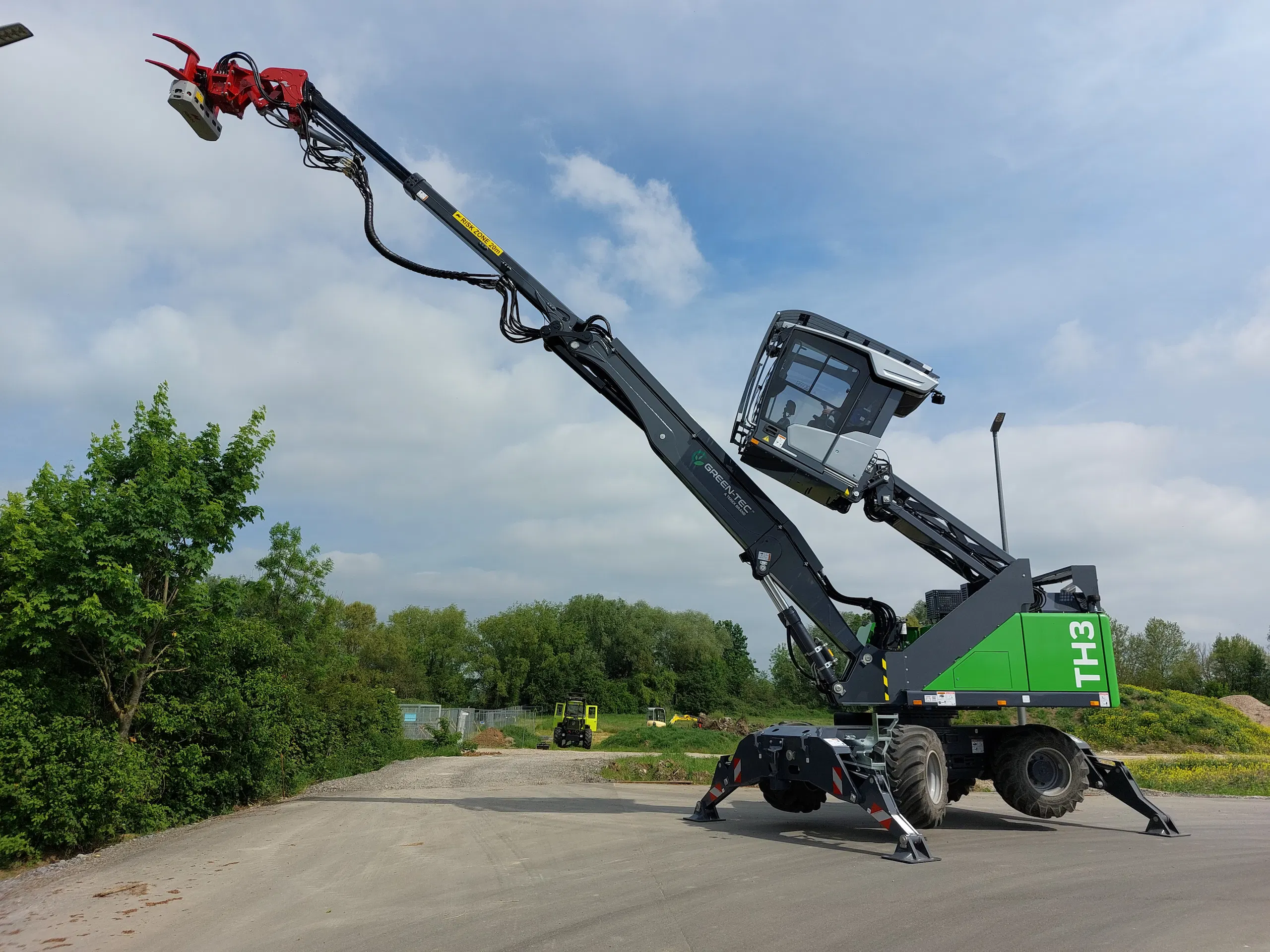 Green-Tec TH3 mobile material handler featuring an extended boom configuration for increased reach in tree care and timber handling operations.