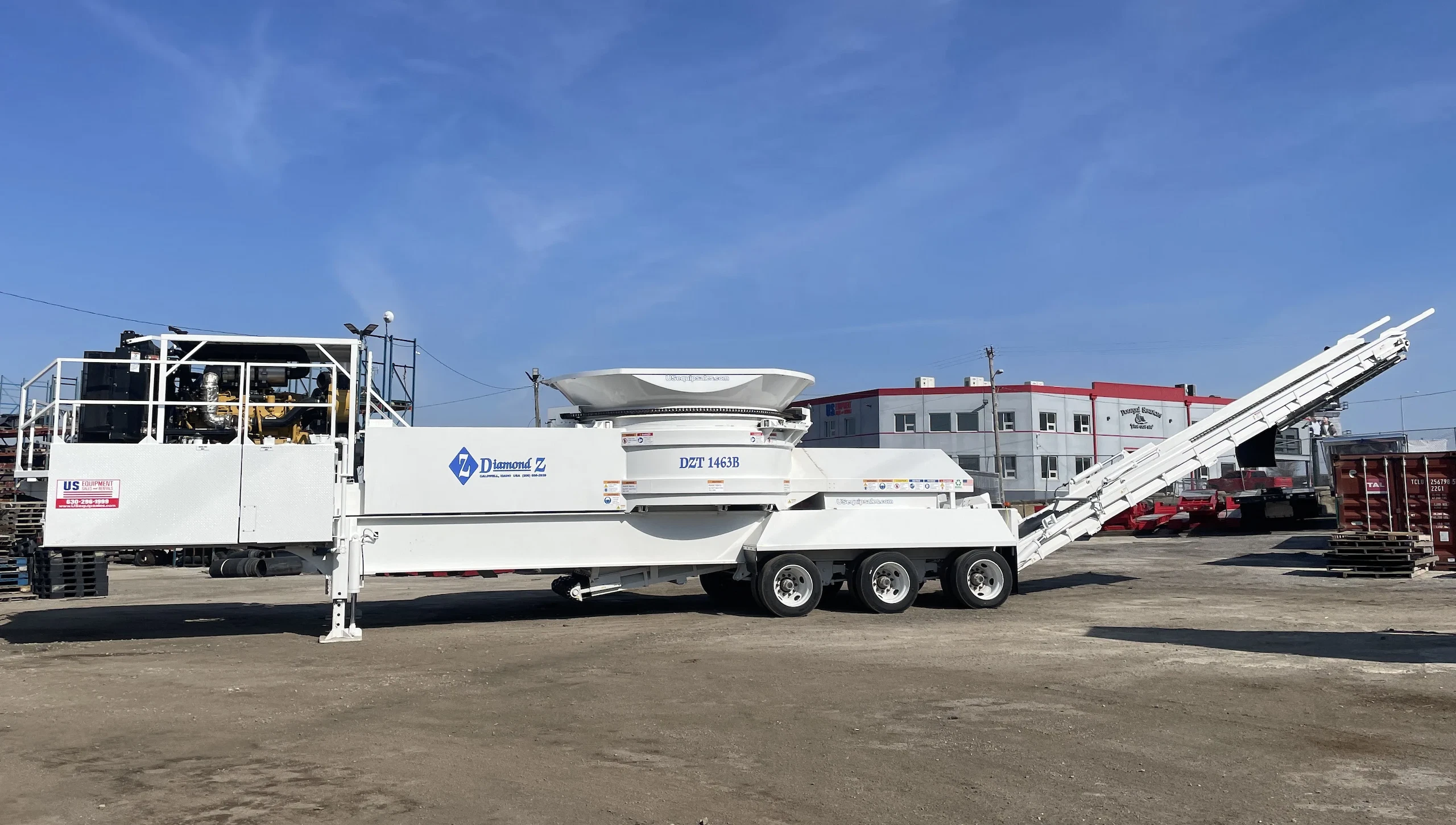 Diamond Z DZT 1463B tub grinder on a tri-axle trailer, built for heavy-duty wood grinding and biomass processing.
