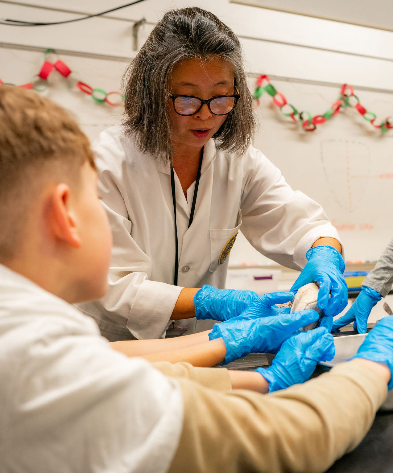 A teacher and student working together on a project.
