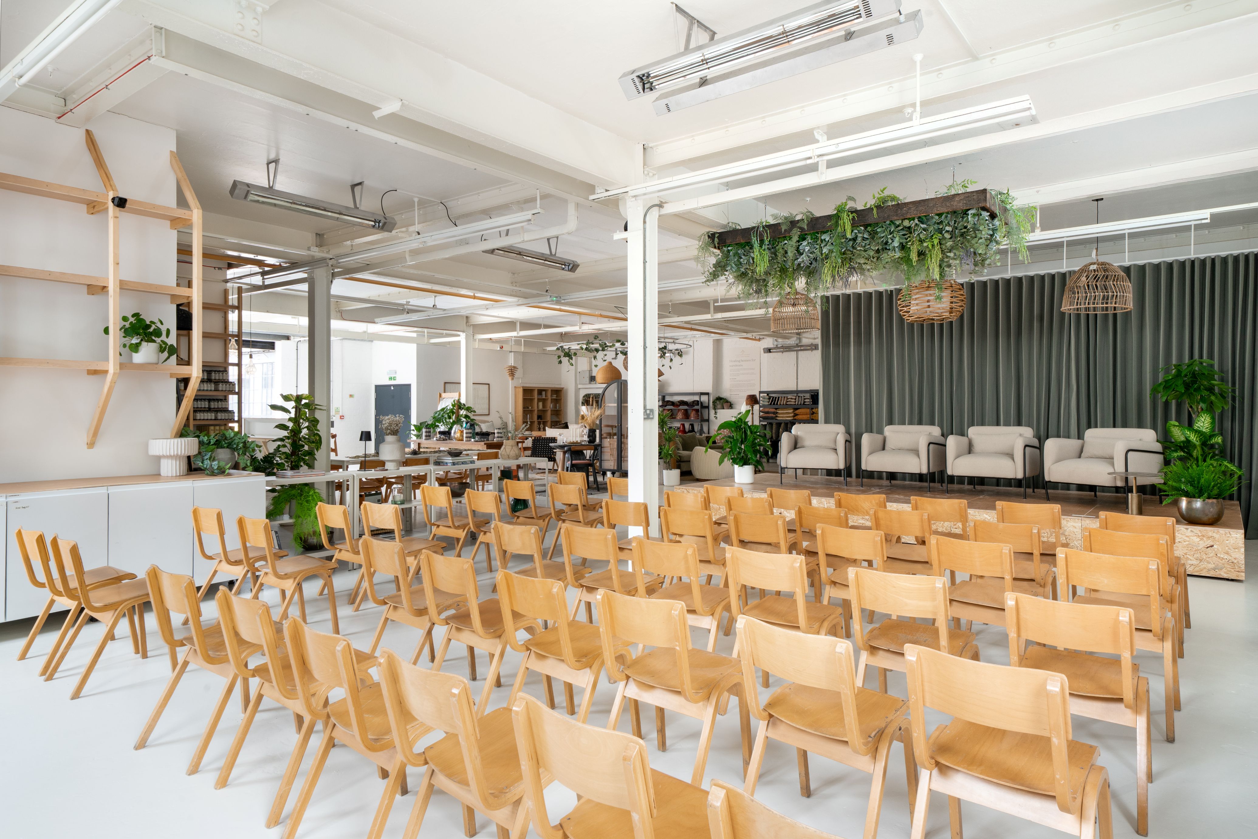 6 rows of chairs facing a stage ready for 4 speakers