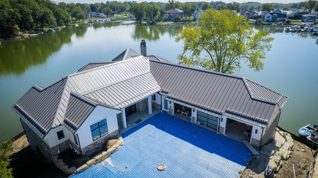 residential home next to lake new metal roof