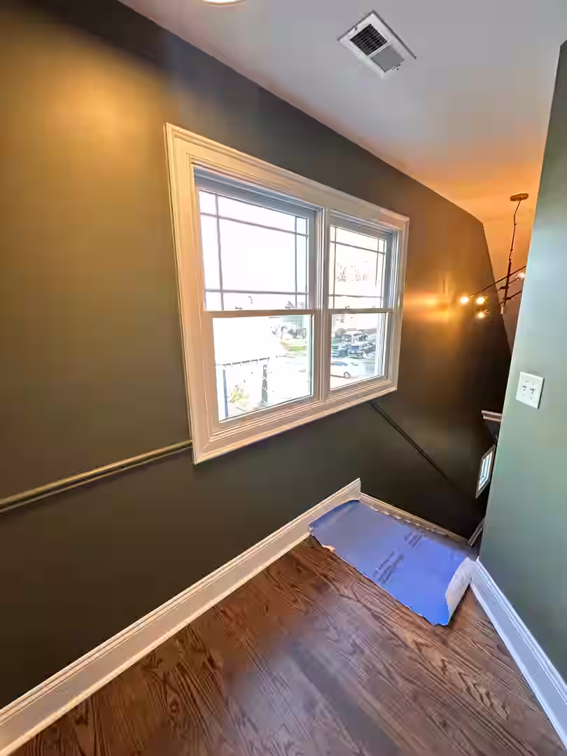 A modern living room with a freshly painted accent wall, showcasing vibrant colors and clean lines - charlotte nc painting company