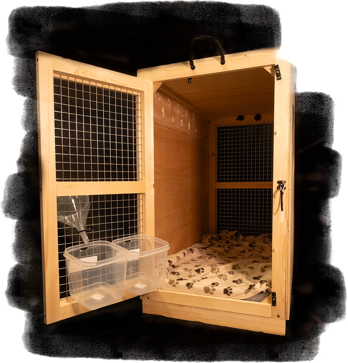 A portrait image of a custom built wooden crate with an open door, with  water and food bowl attached.