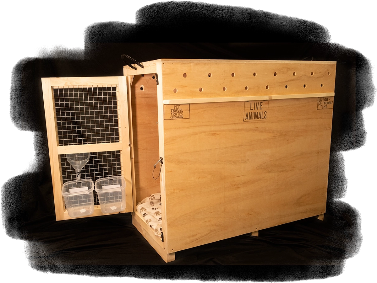 A landscape image of a custom built wooden crate with an open door, with  water and food bowl attached.