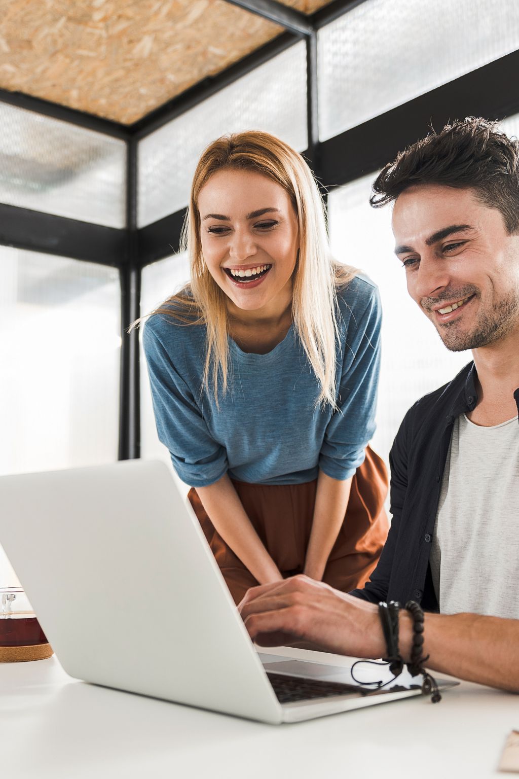 Coworkers overlooking work on a laptop together