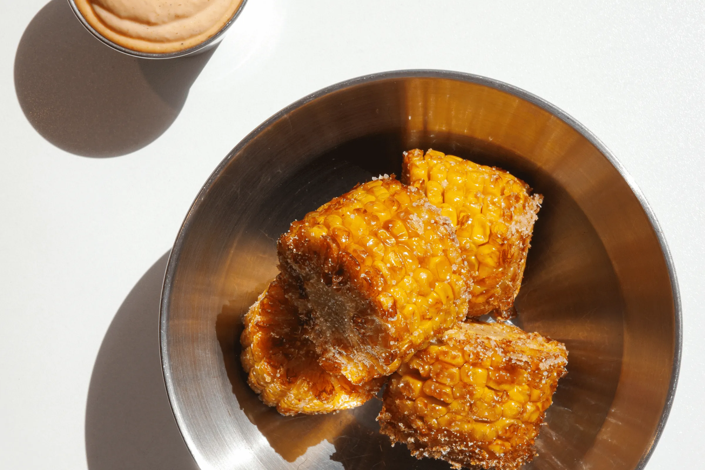 Crispy fried corn on the cob from Won Chickin served with a creamy dip