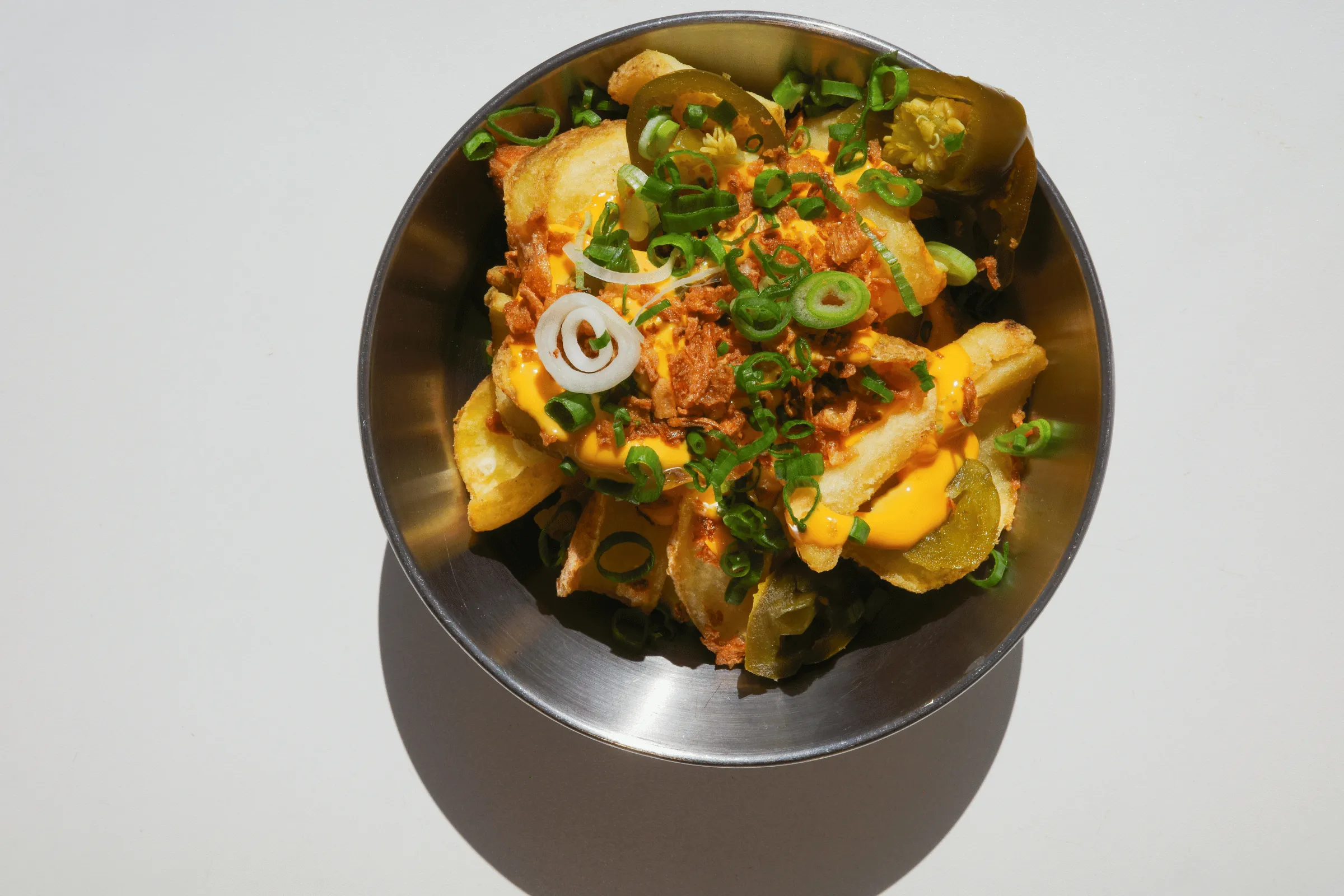 Loaded potato dippers with cheese sauce, jalapeños, crispy onions and spring onions