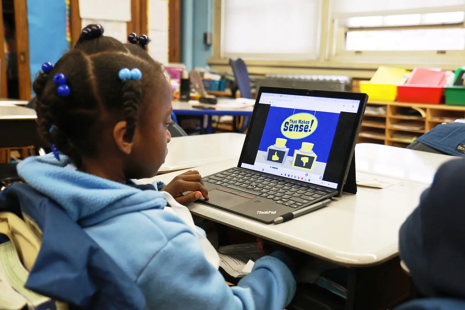 Student using laptop for educational program in classroom