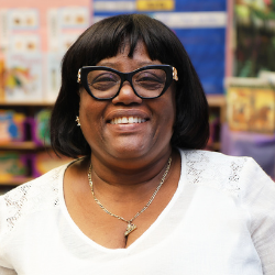 Marcia Codner Dwyer smiling in a classroom setting