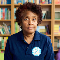 Elizabeth Williams staff member standing in front of bookshelf