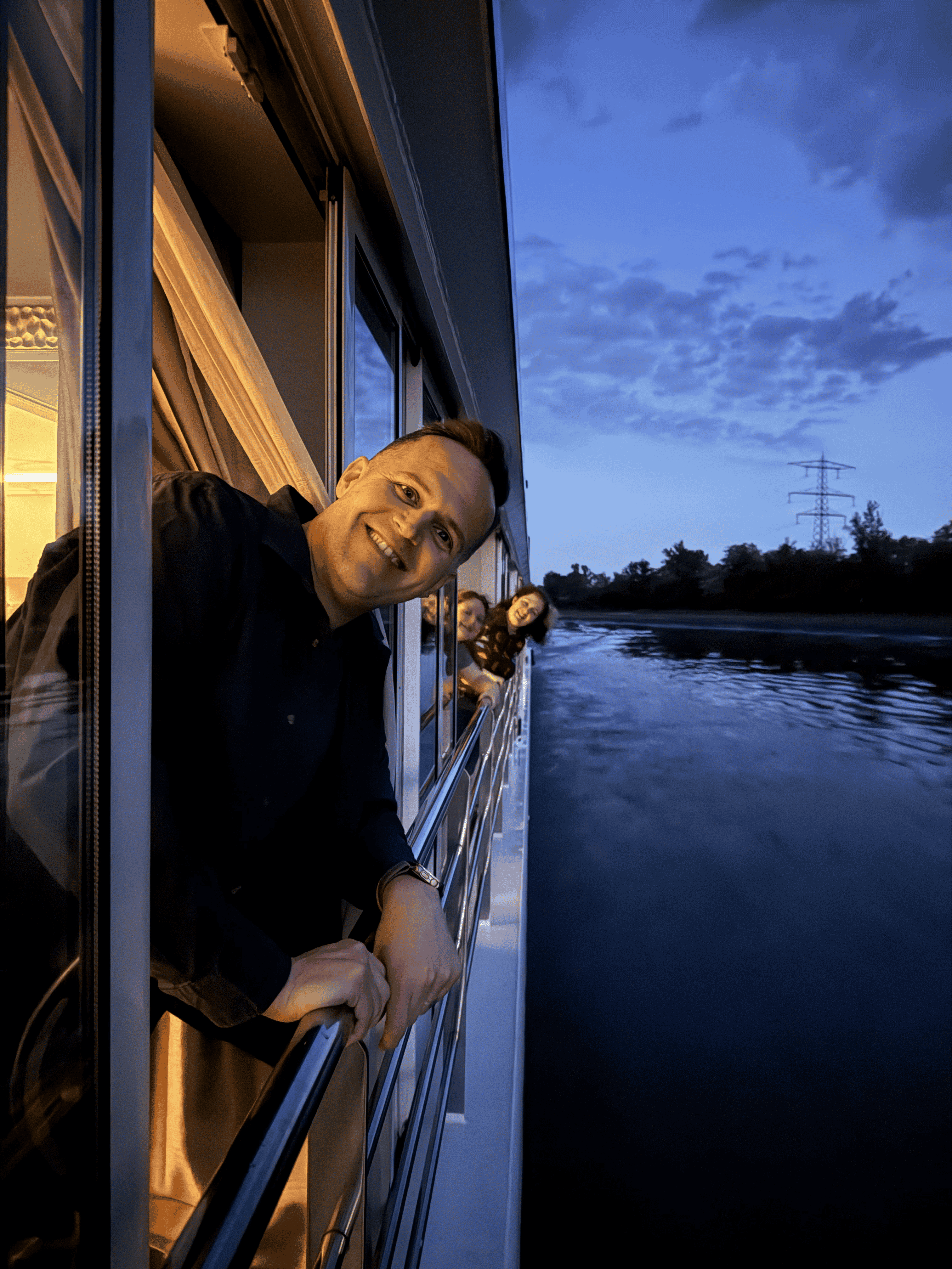 Three people looking off the side of a cruise