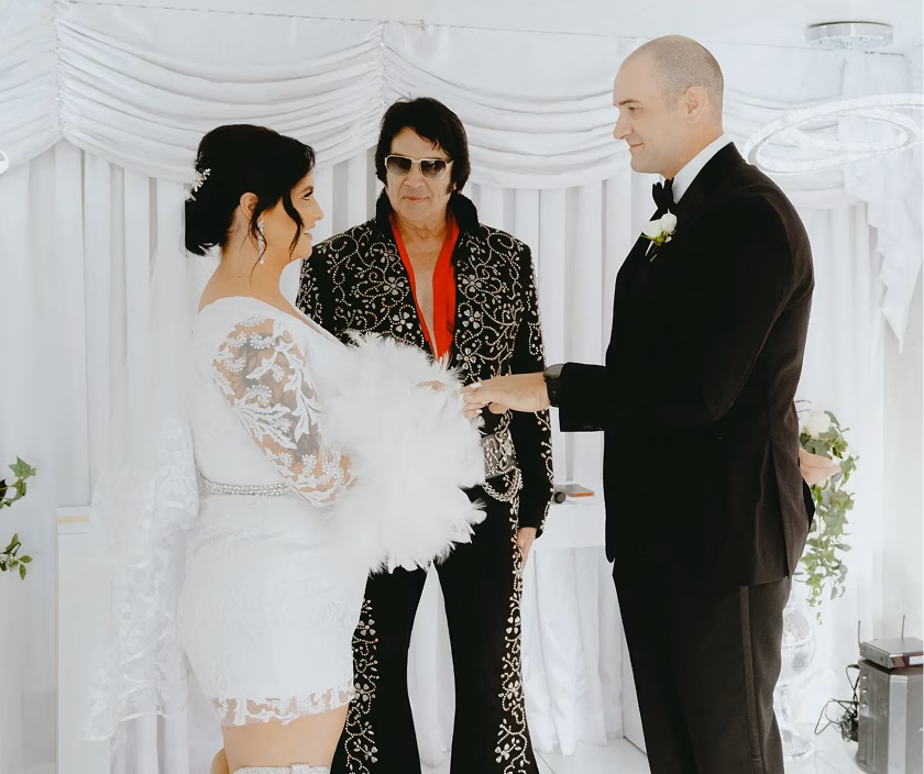 Hope and Jonathan's intimate Las Vegas chapel wedding, with Elvis officiating their stylish ceremony in white-draped setting