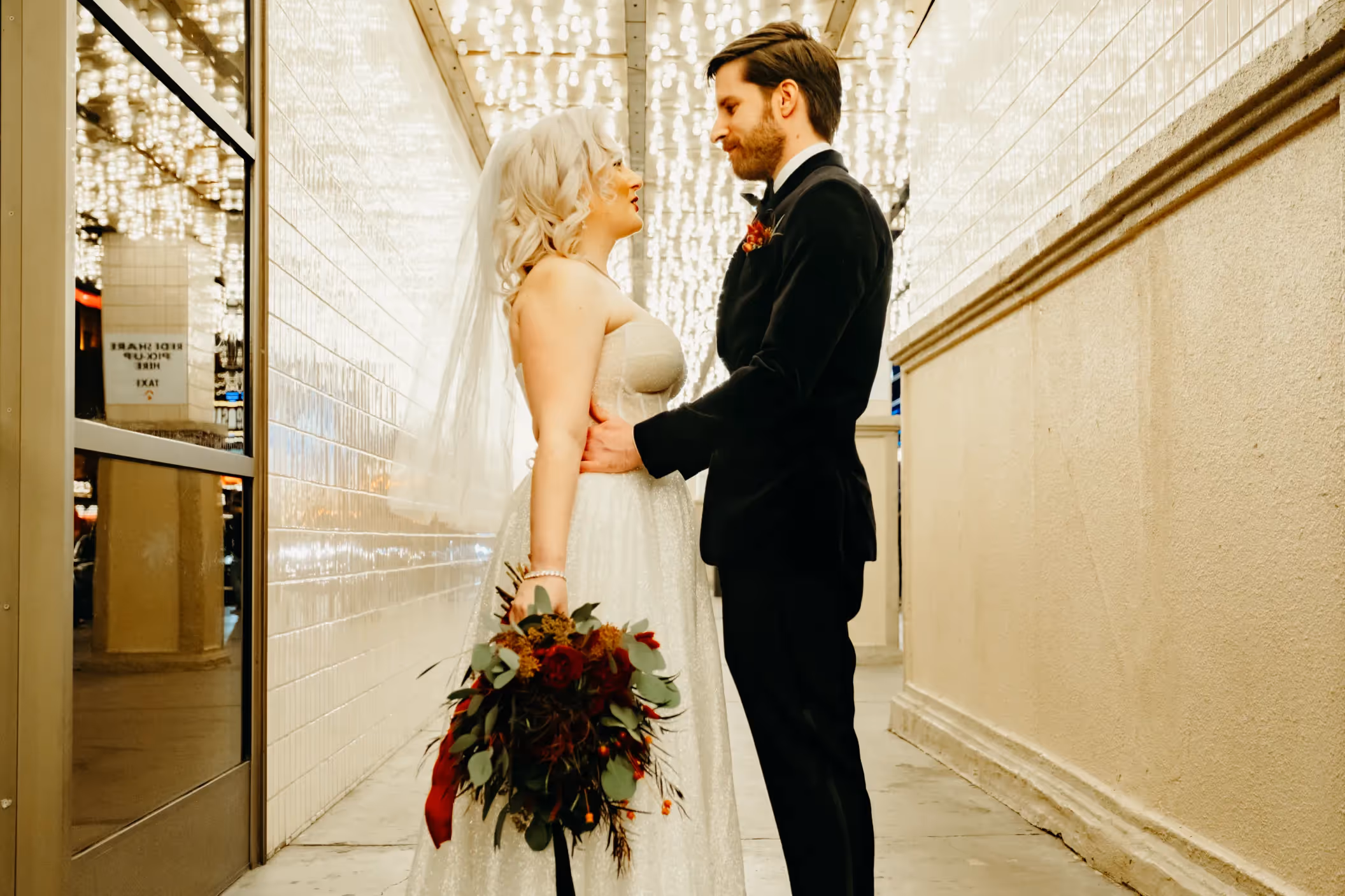 Kelsi and Oliver's glamorous Downtown Las Vegas elopement, couple in vintage-inspired attire strolling past retro tile artwork