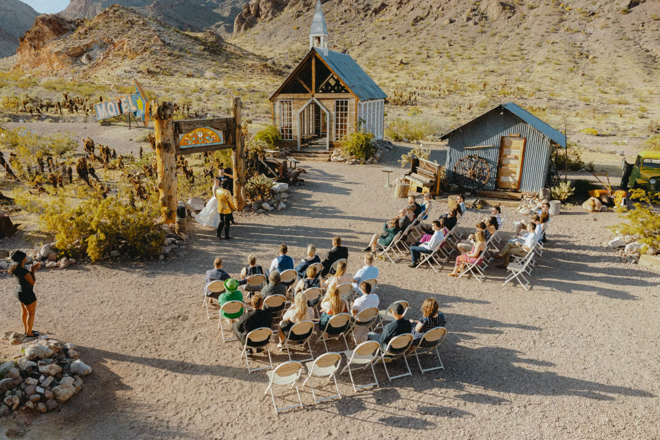 Nelson Ghost Town wedding ceremony for Mackenzi and Connor, couple exchanging vows inside charming chapel with stained glass windows near Las Vegas