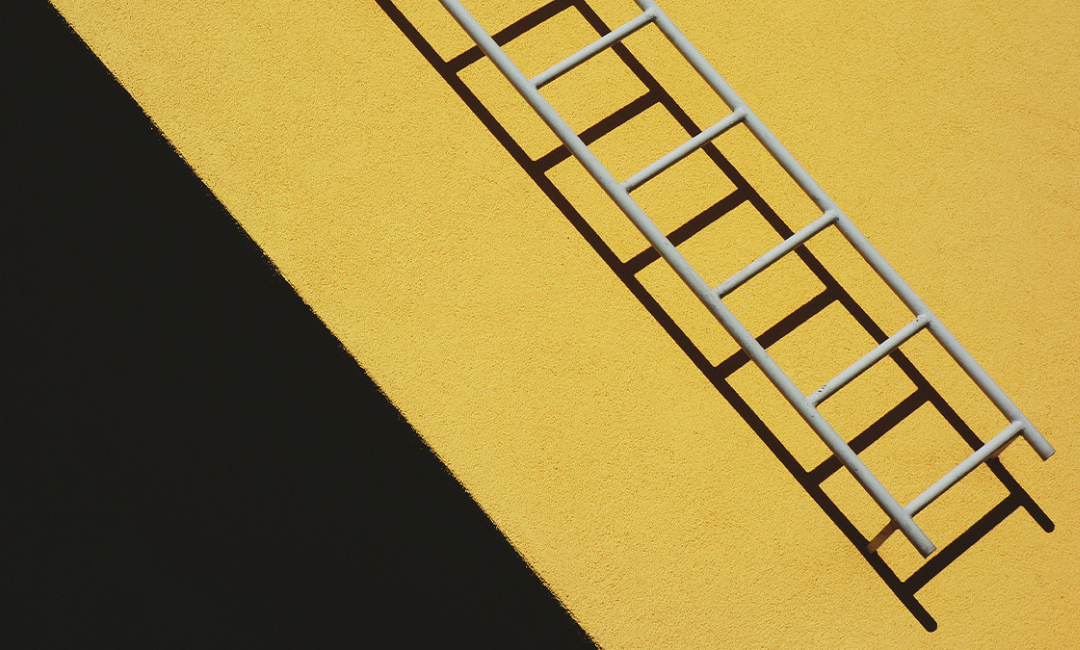 a ladder on a yellow background