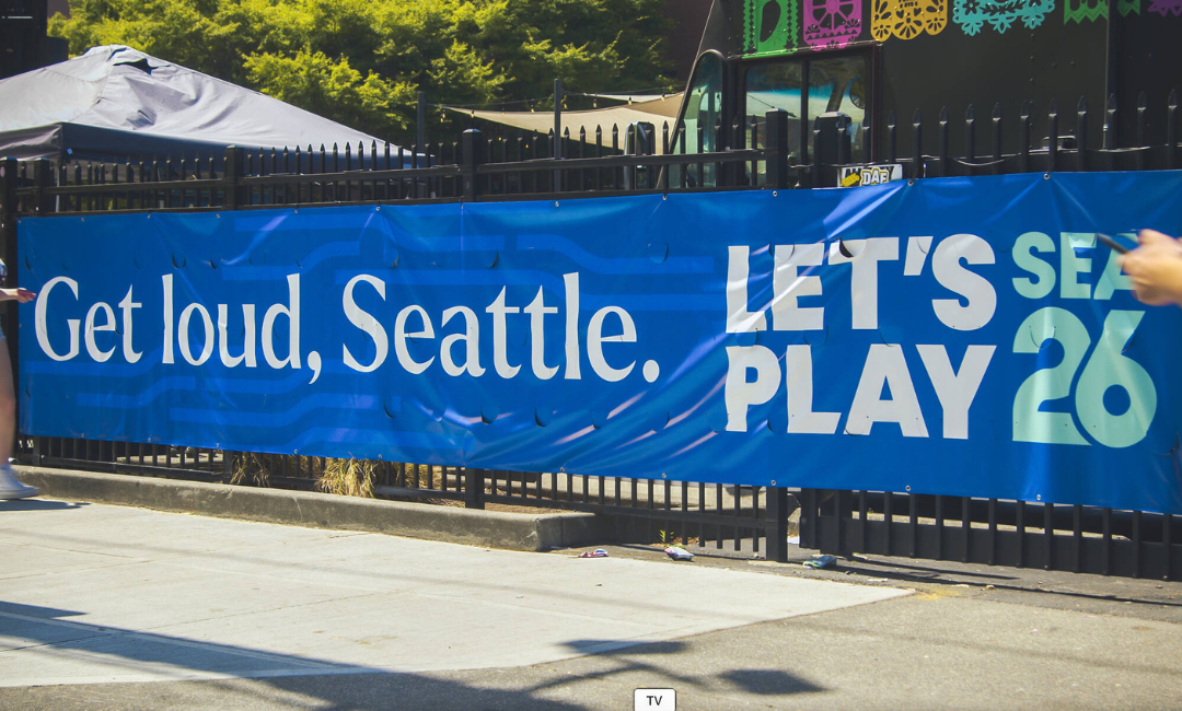 banner on a fence that says "Get Loud, Seattle"