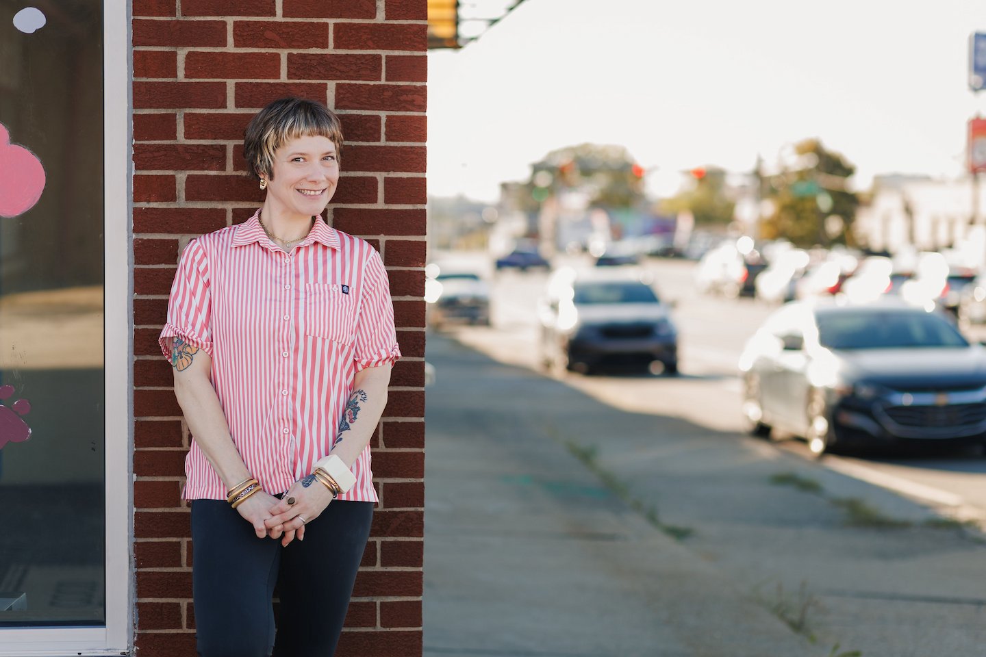Owner, Mollie Smith posing in front of Good Golly Pet Salon