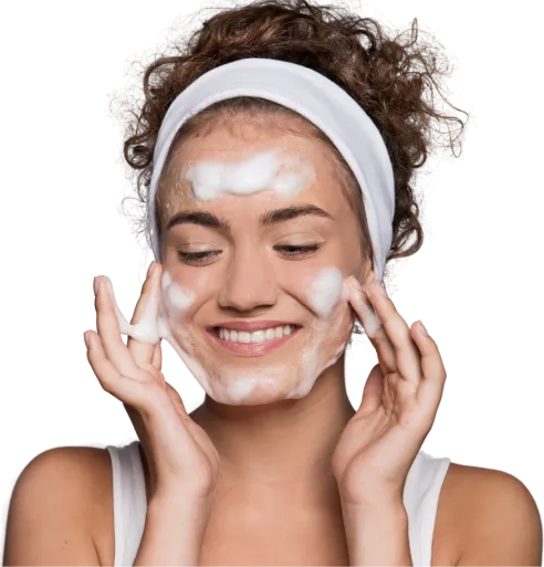 A woman with a white towel on her head and a white mask on her face.