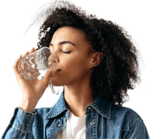 A woman drinking a glass of water.