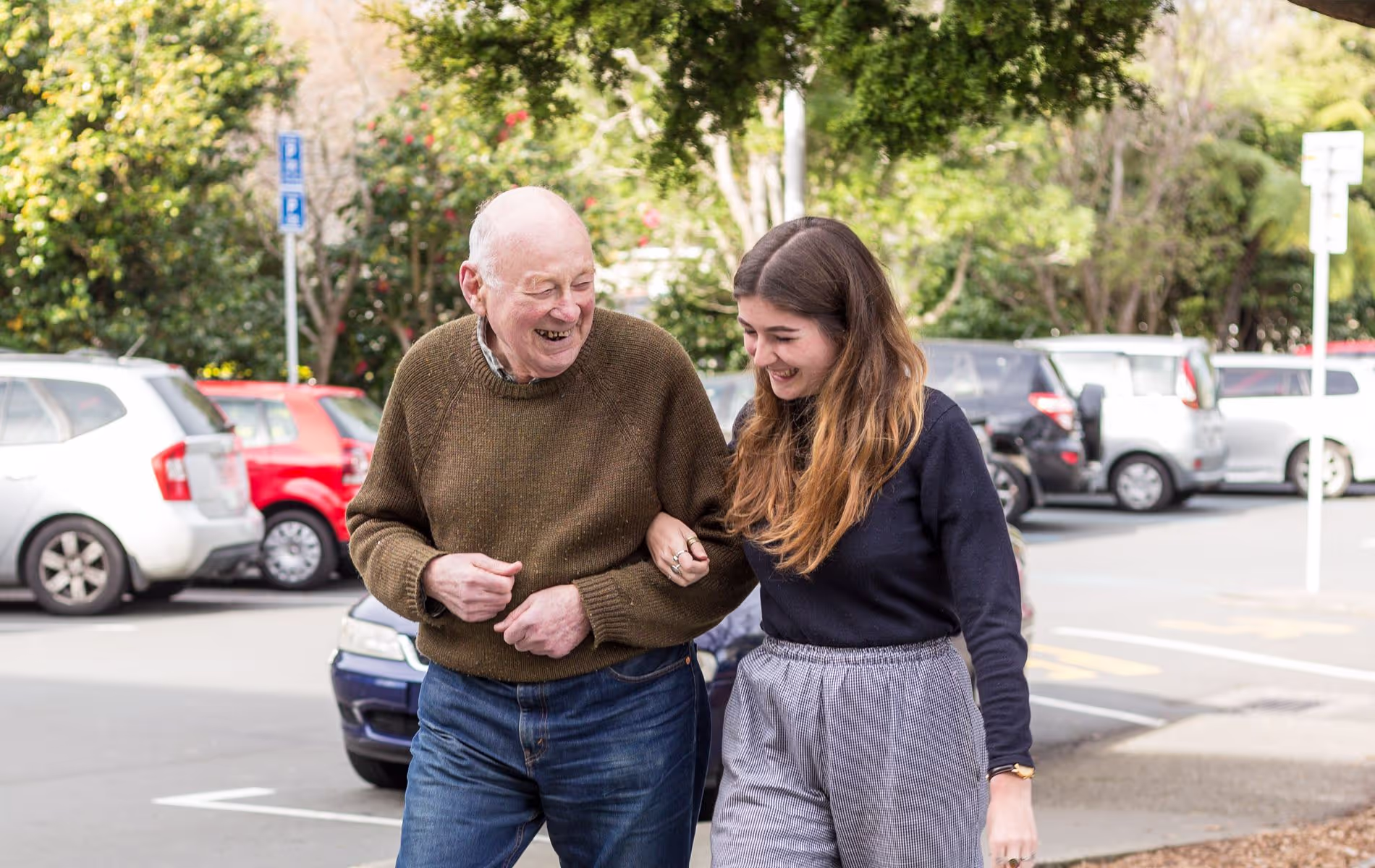 A young lady walking with an elderly man