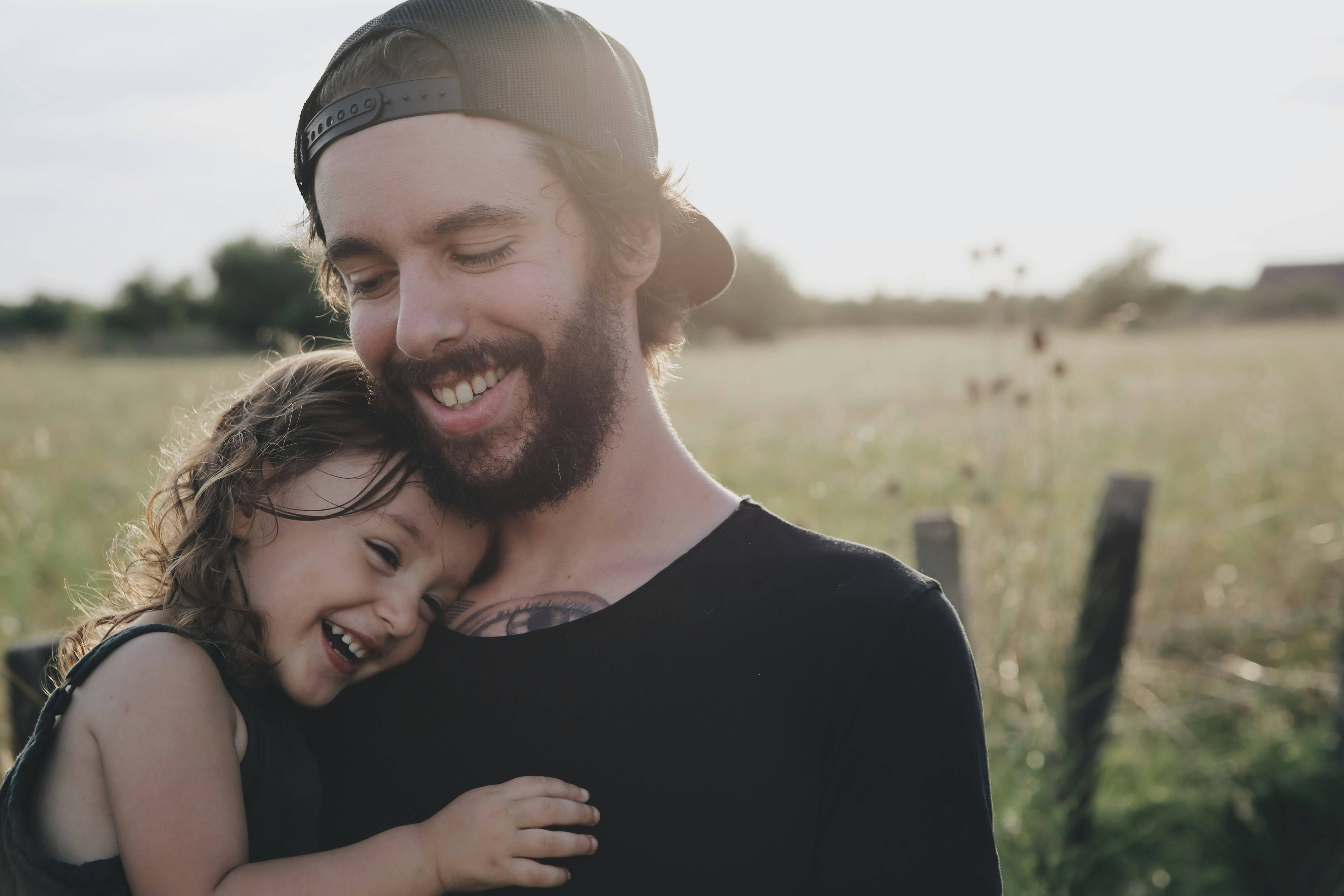 Father and daughter smiling and embracing