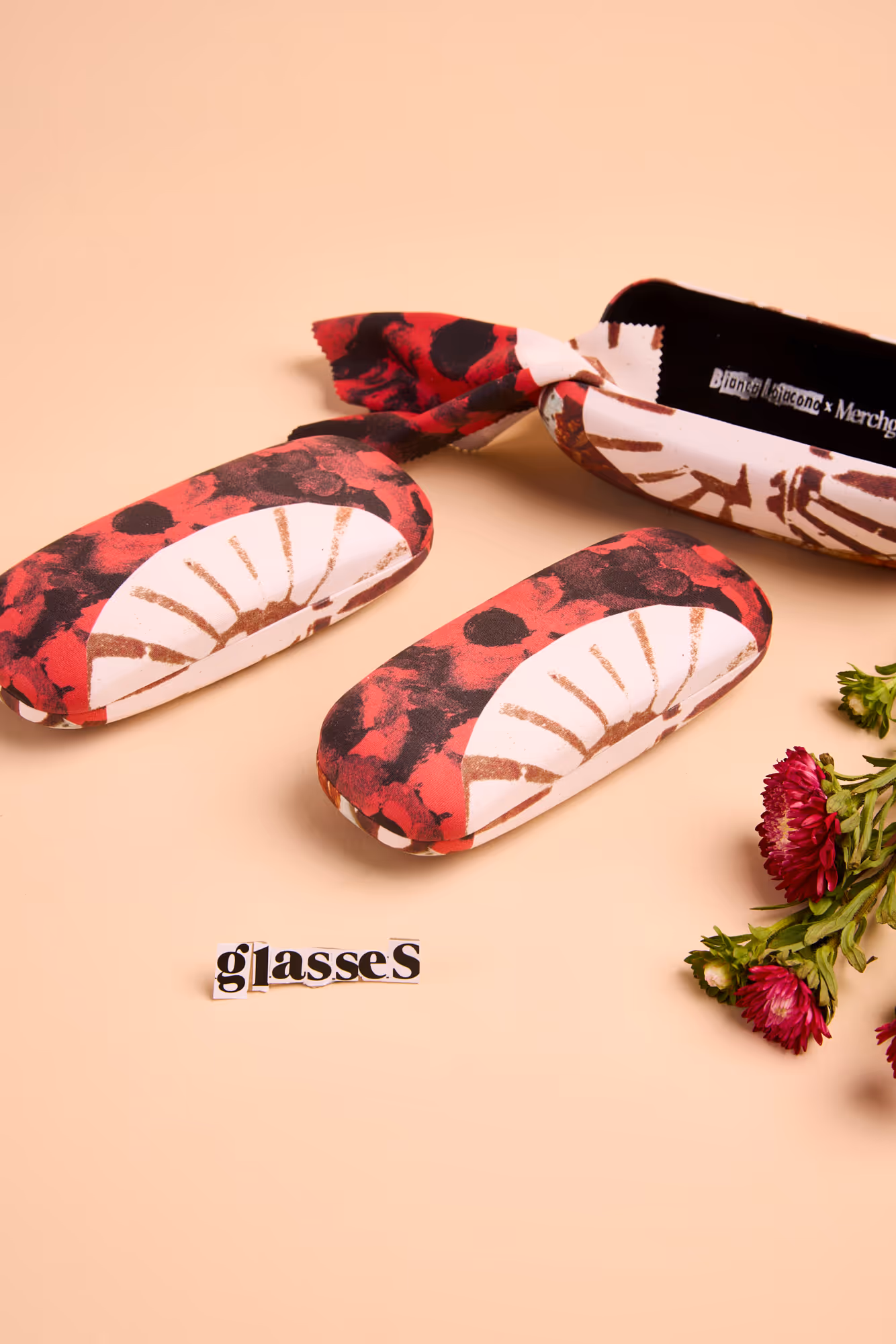 Full-print branded sunglass cases and lens cleaners designed for gallery stores and retail environments