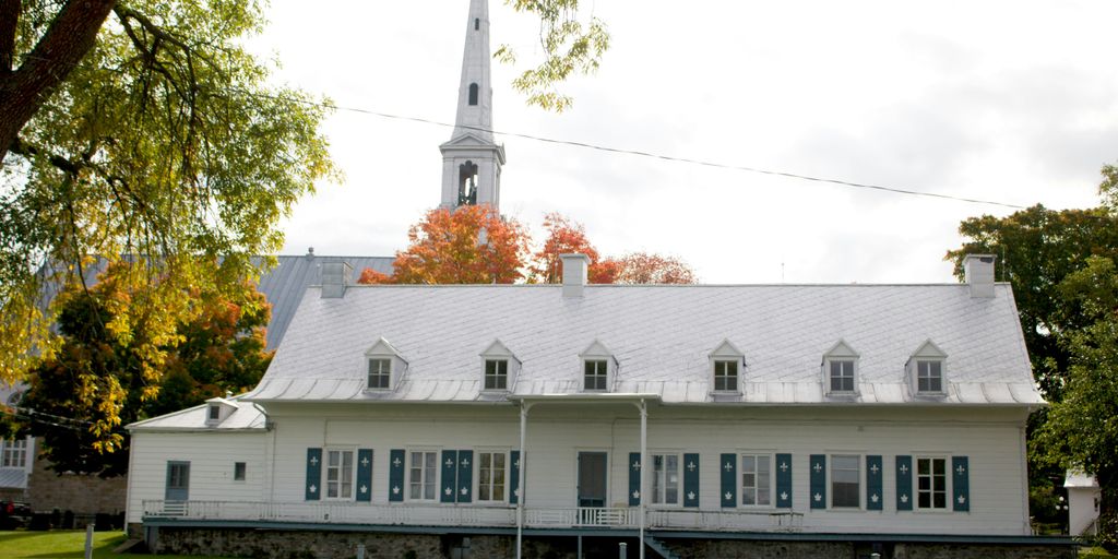 A large white church with a steeple on top of it