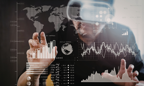 Person wearing virtual reality headset interacting with transparent screen displaying various global data charts and graphs.