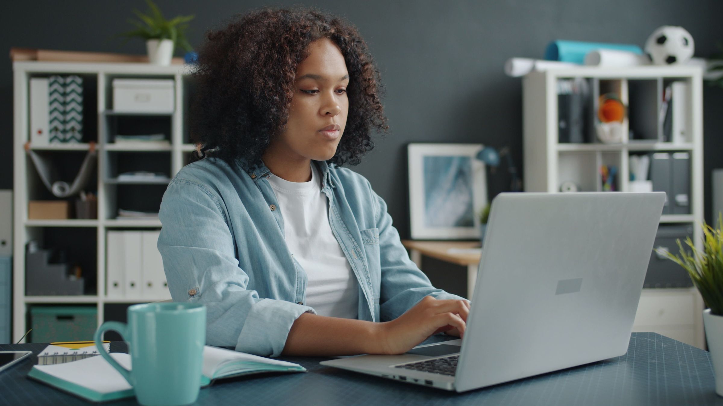 An employee working at a laptop in an office