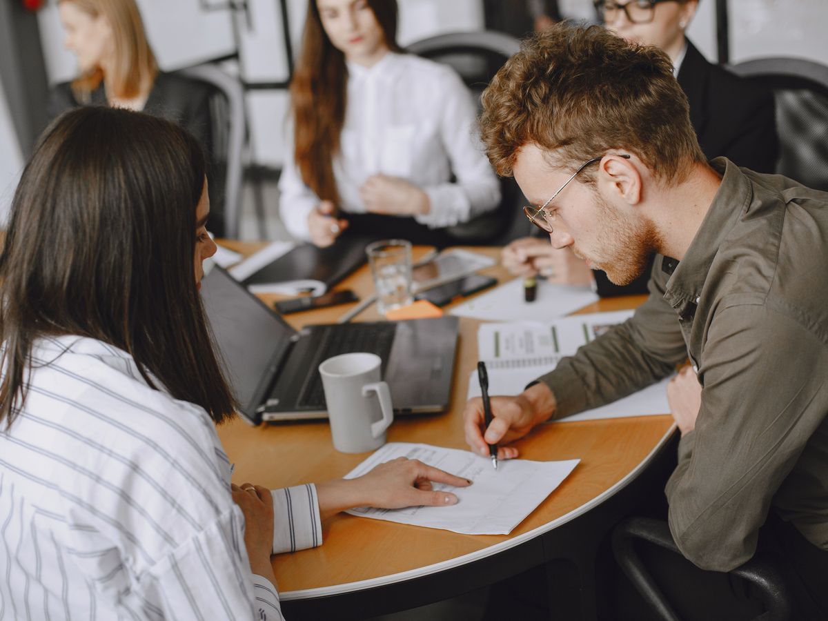 Colleagues reviewing a document together at a meeting table