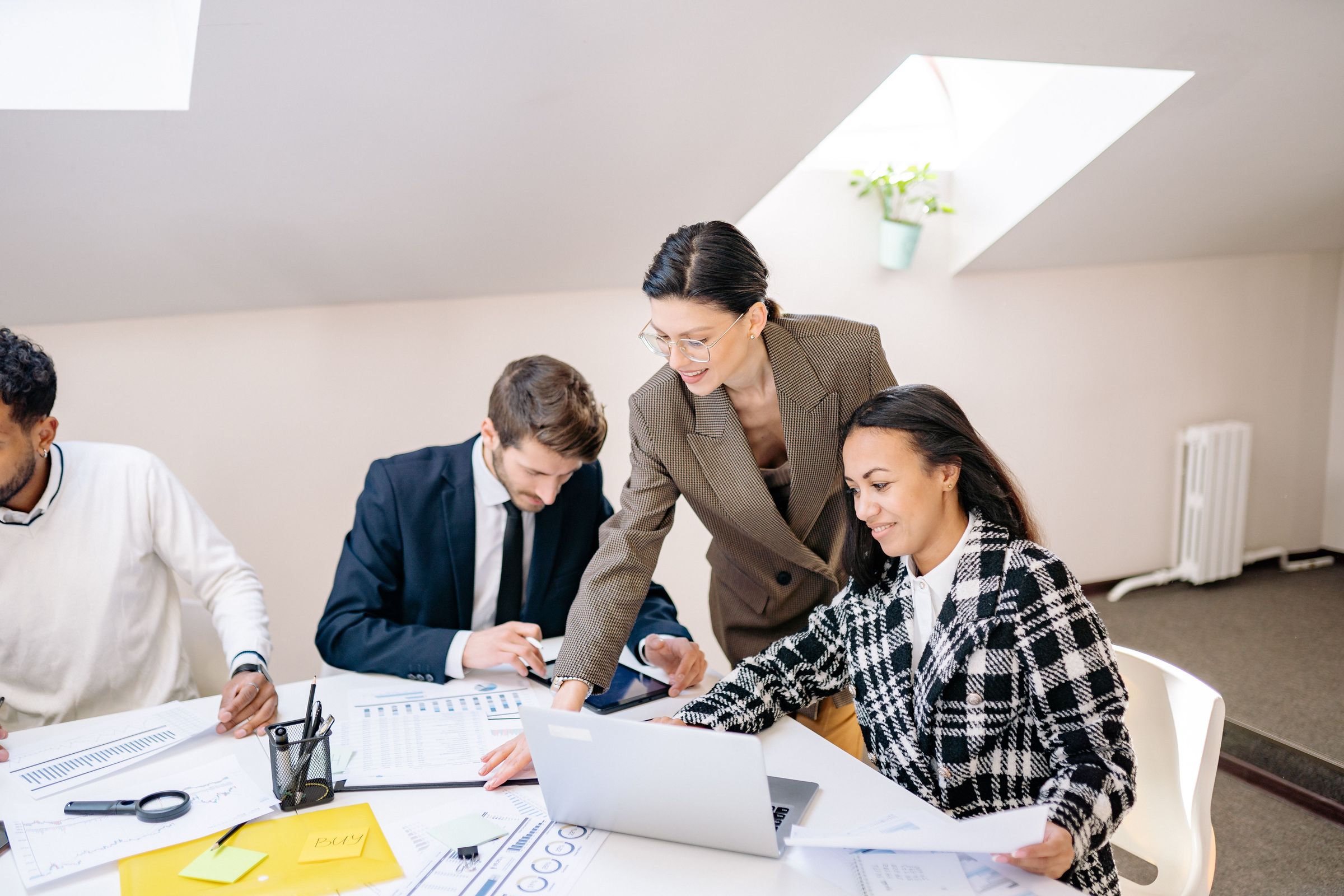 Advisers reviewing client data together at a laptop