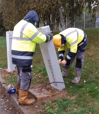 deux installateurs irve installe des bornes de recharge pour voiture électriques Qovoltis