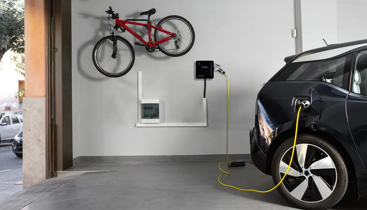 Home charging station installed in a garage for an employee's electric vehicle