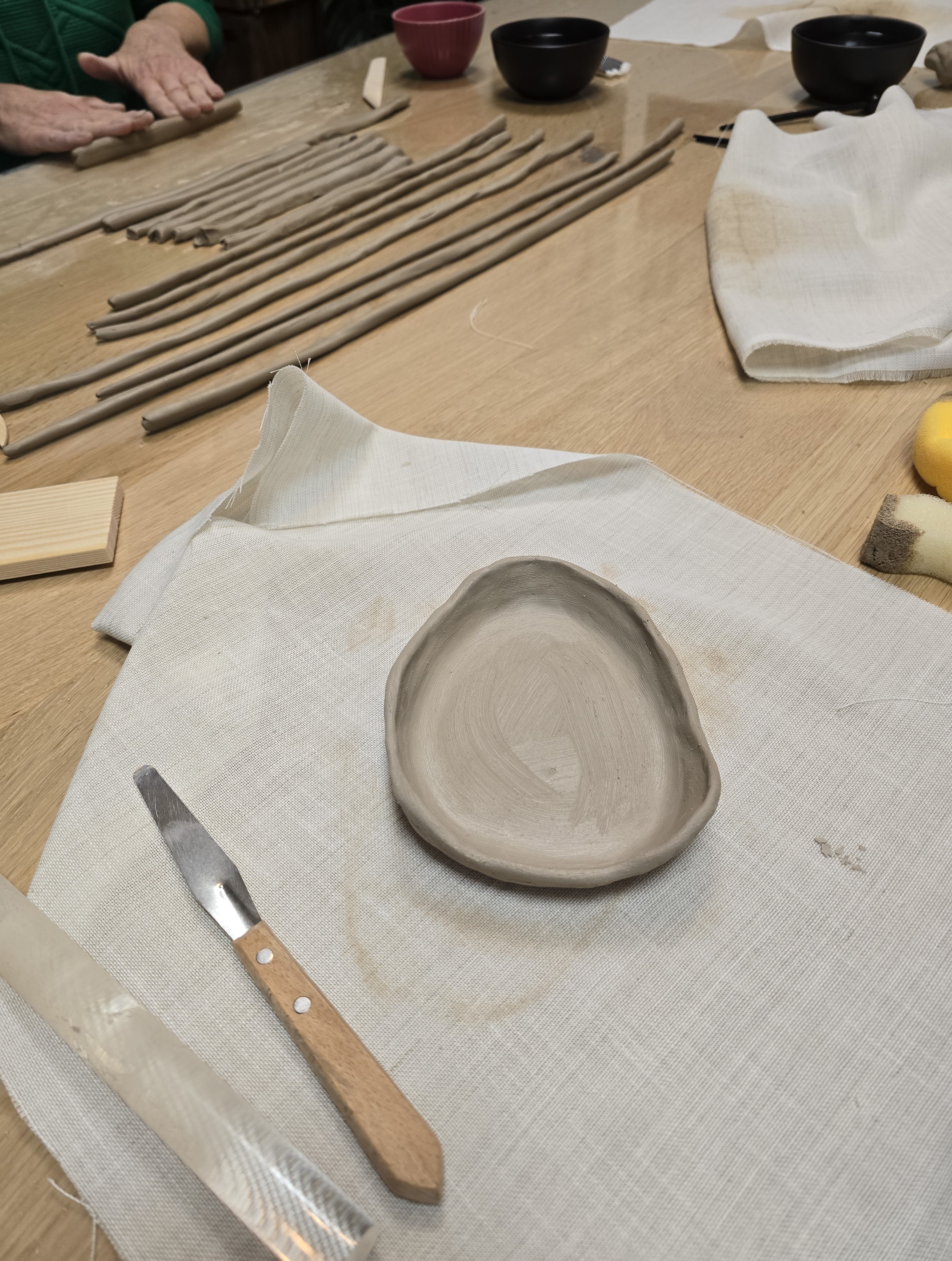 Burger with fried fries on black plate with sauce on the side