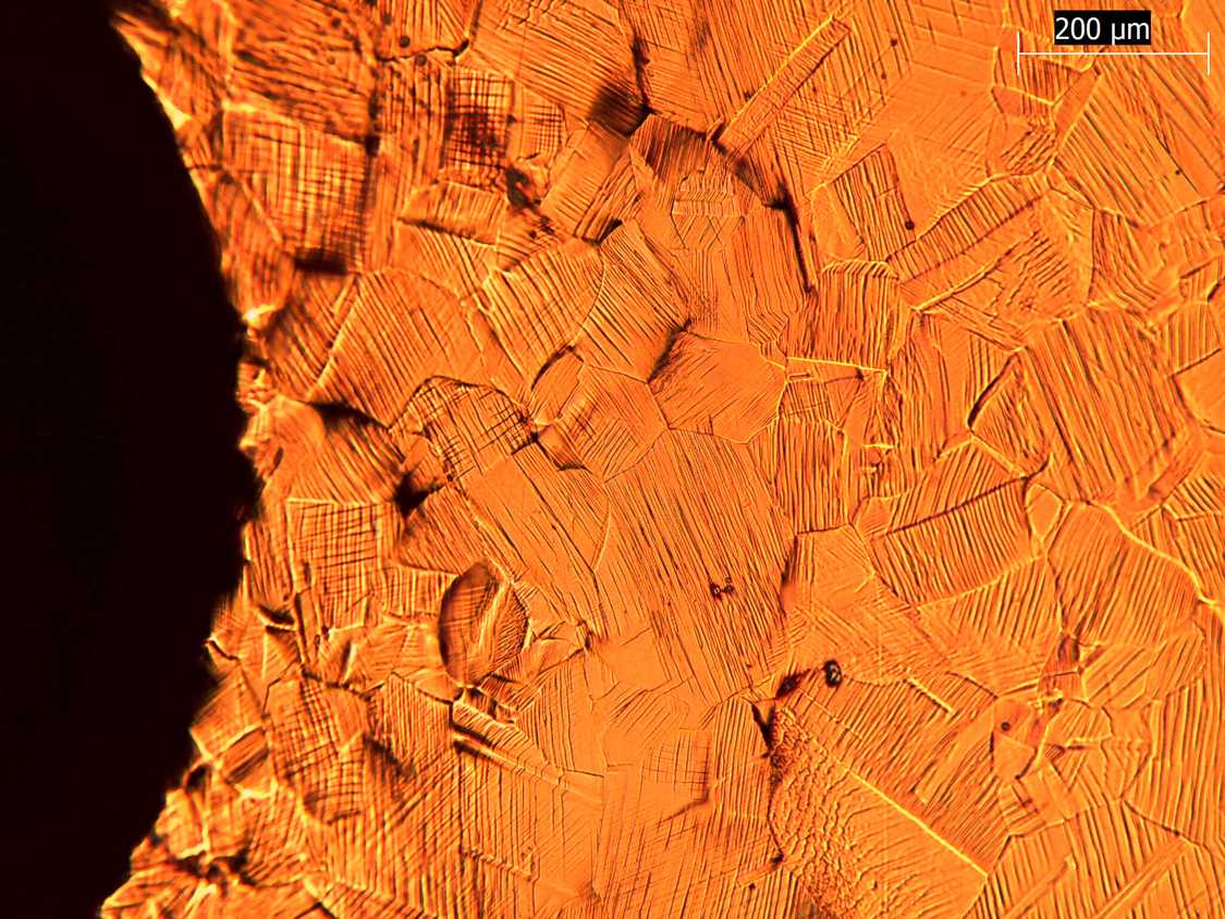 1Optical micrograph of the free surface of a copper sample, near to an indent created with a spherical indenter of radius 1 mm.