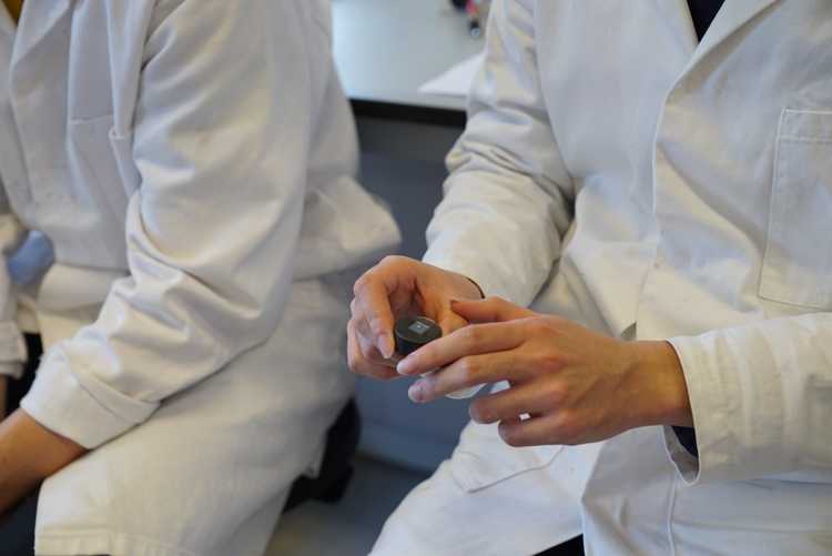 A student holding an indentation sample