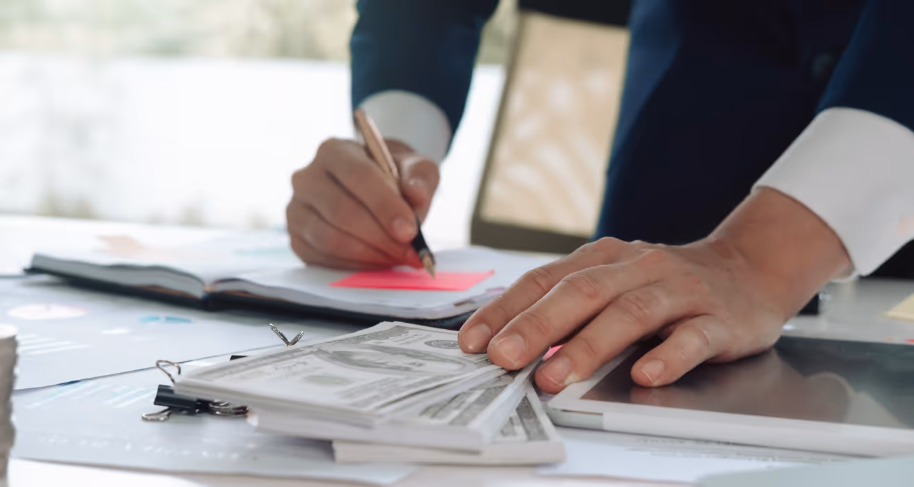 Escrow fees being calculated and divided between buyer and seller during the closing process of a real estate transaction.
