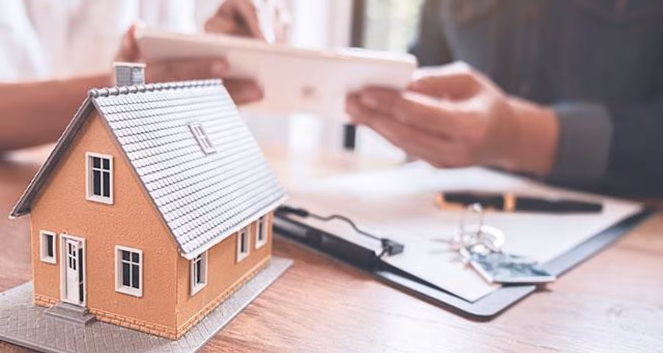 Couple reviewing home refinance options before selling their house, considering potential savings and market conditions