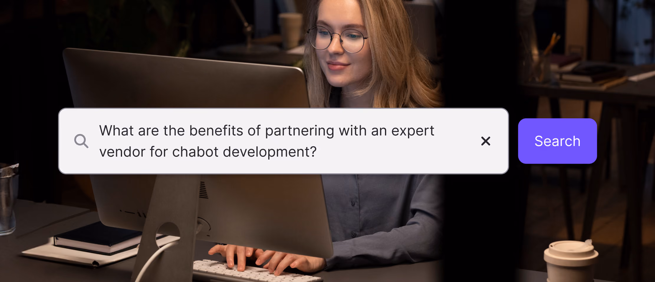 Woman researching benefits of expert chatbot development partnership on computer in a cozy office setting.
