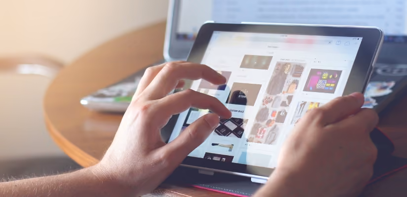 User using a tablet for multichannel marketing, ideal for chatbot strategy discussions.